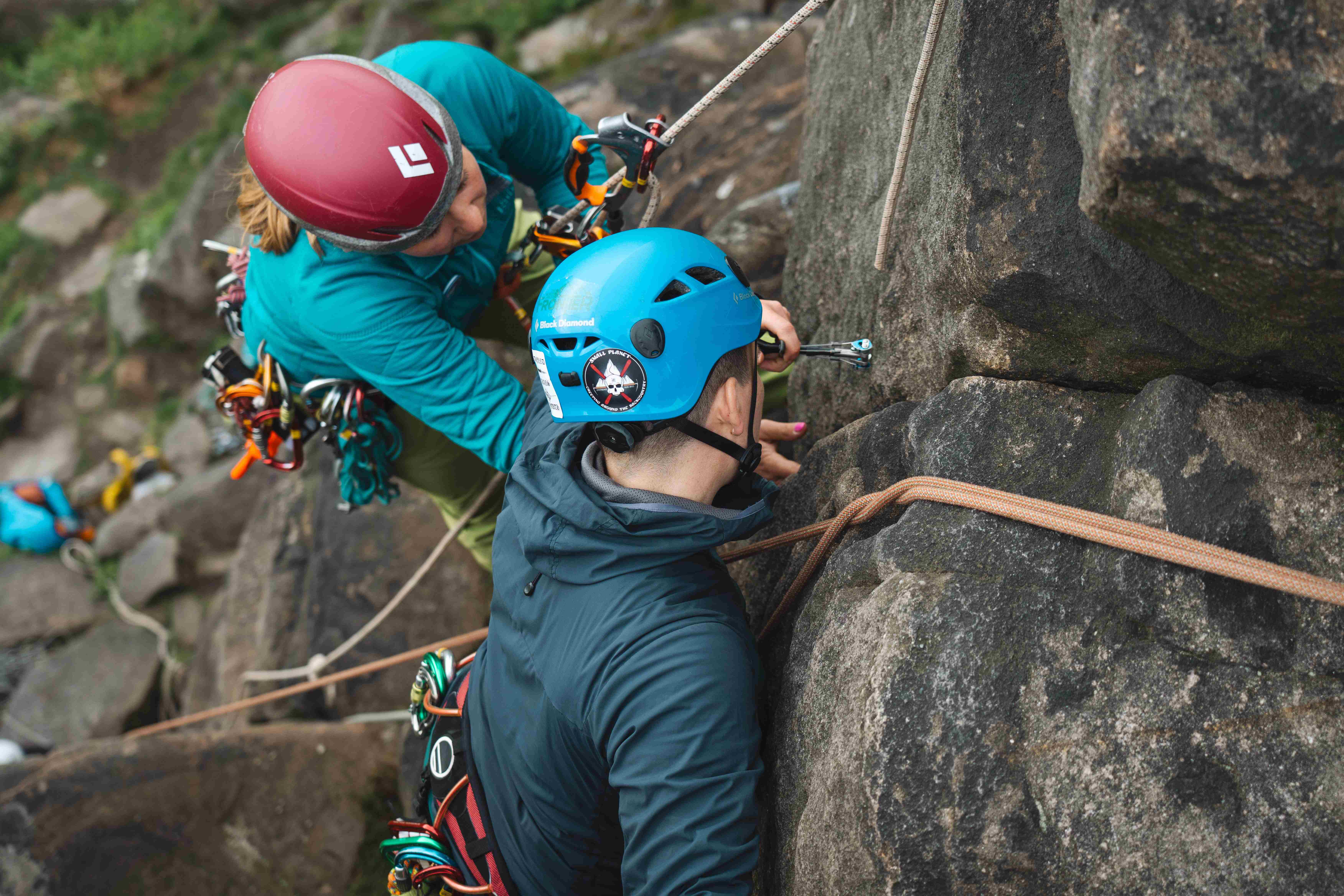Mountaineer and instructor climbing rocks