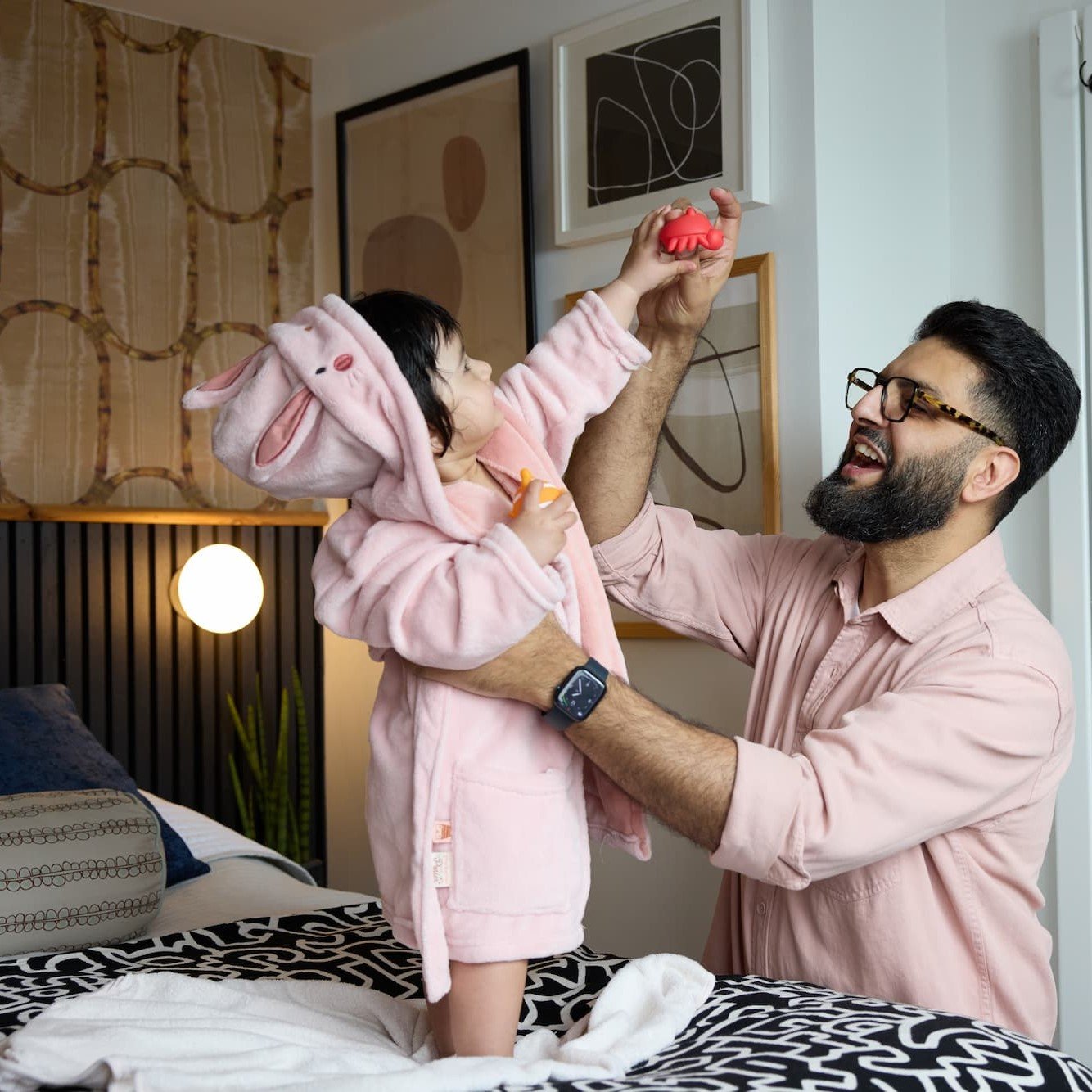 Dad with young daughter playing a game after bathtime