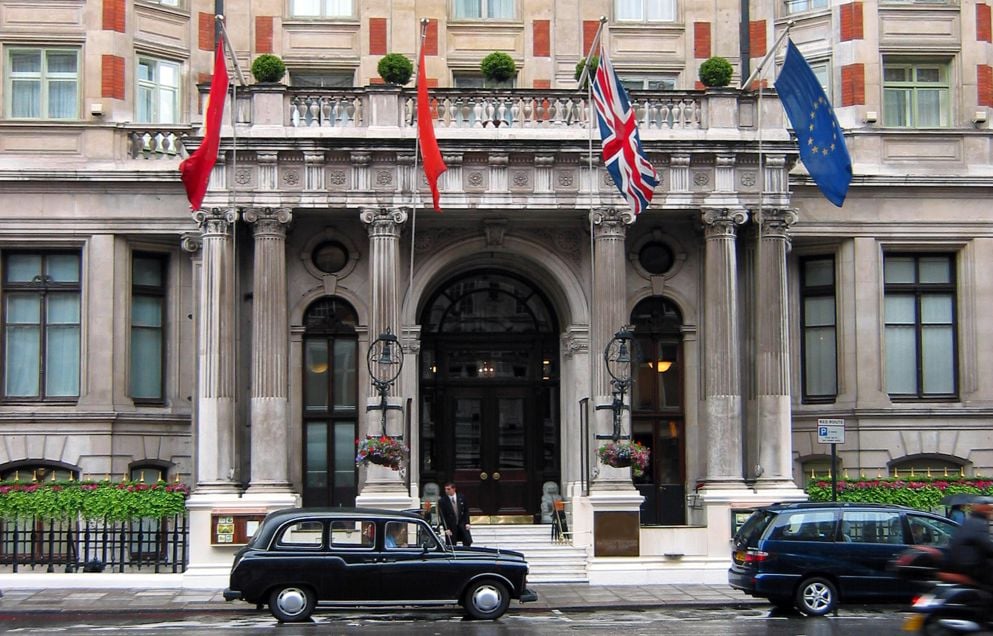 An ornate luxury hotel on a rainy day.