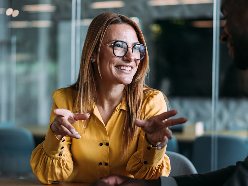 Woman in office smiling at a conference table