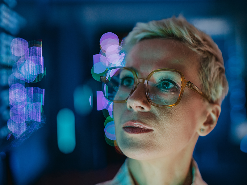 Woman working in a data centre focused on data analysis