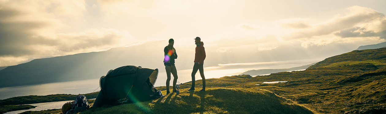 Two hikers admiring a view from a mountain