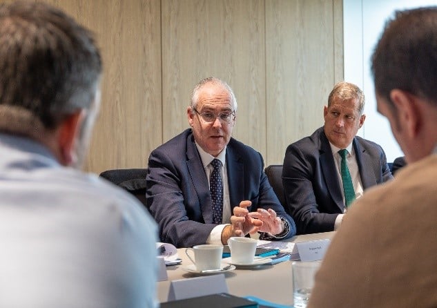 Solicitors at a table talking over coffee