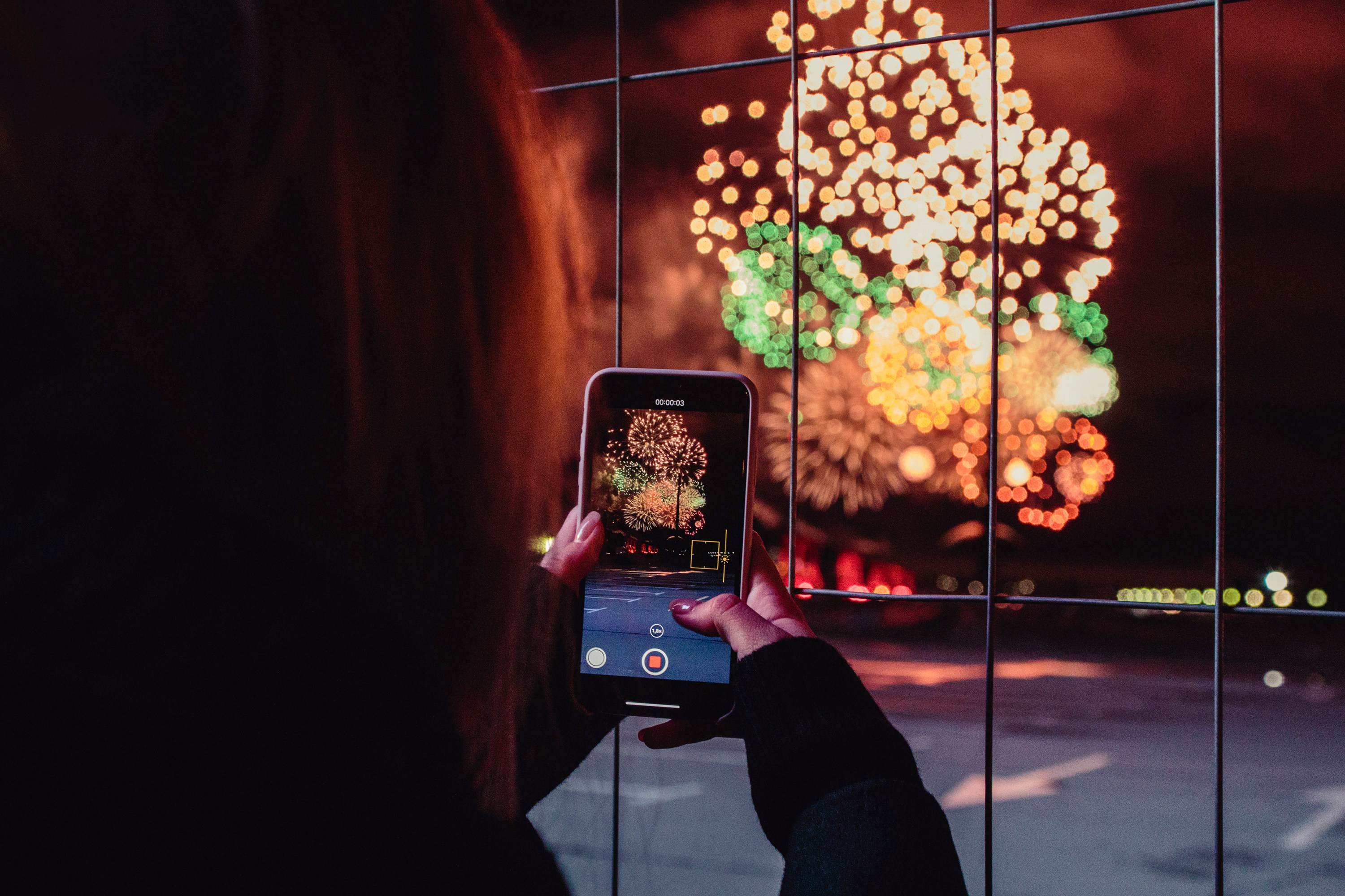 Child taking photos of fireworks