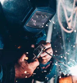 A welder is working, with sparks flying