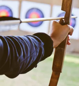 Archer aiming at target board