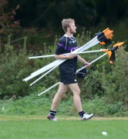 Coach collecting corner flags