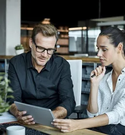 Colleagues looking at a laptop