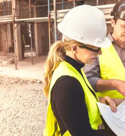 Construction site workers looking at plans