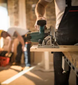 Man using electric saw on a construction site