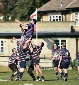 Rugby players' lineout outside the club house