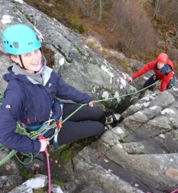 Pair of mountaineers climbing a hill