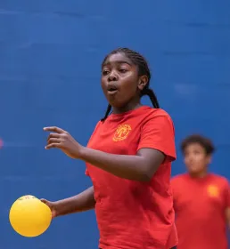 Girl about the throw dodgeball