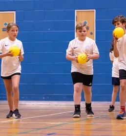 5 children doing dodgeball practice