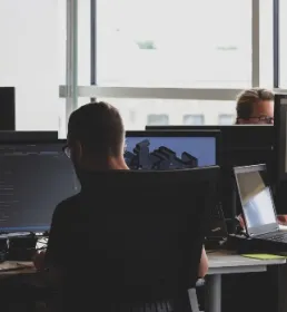 office of business people at desks on computers