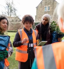 Community group in high-vis working together outdoors