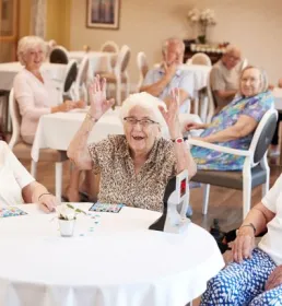 Older people sat enjoying a group activity