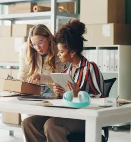 women looking at tablet in workspace
