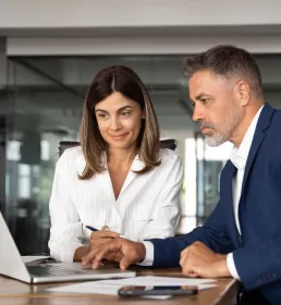 business people in a meeting working on a laptop