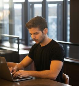 Man at desk in office working on laptop