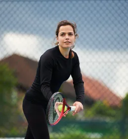 Girl getting ready to serve a shot in tennis