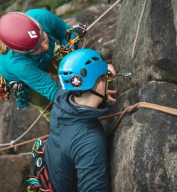 Mountaineer and instructor climbing rocks