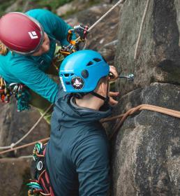 Mountaineer and instructor climbing rocks