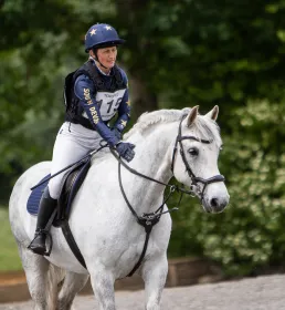 Woman riding white horse
