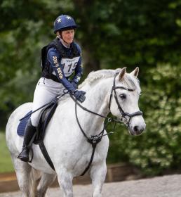 Woman riding white horse