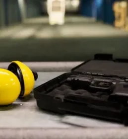 gun and headphones on table