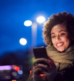 woman looking at her phone in the evening 