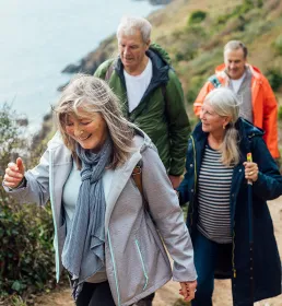 Group of seniors enjoying a coastal walk