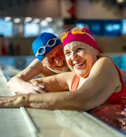 Elderly couple enjoying public swimming pool