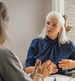 Two woman having intense discussion at a desk