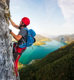 Cliff climbing above lakes mountainside