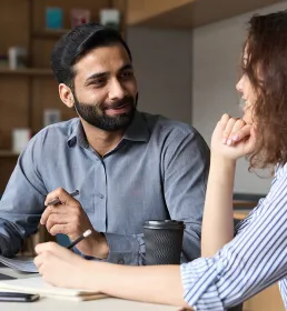 Man and woman working together at a desk