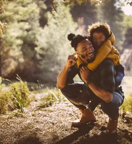 Dad and son playing in forest
