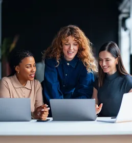 Confident leader presenting laptop to employees