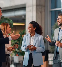Group of professionals laughing and chatting