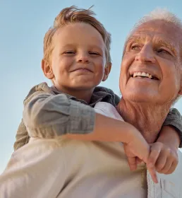 Grandad and grandchild in sunshine
