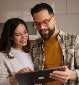 Couple reading tablet together