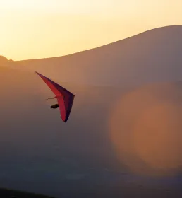 Paragliding across the sunset horizon