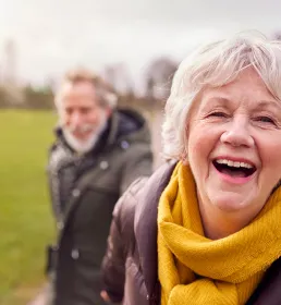 Happy older couple enjoying retirement on a walk