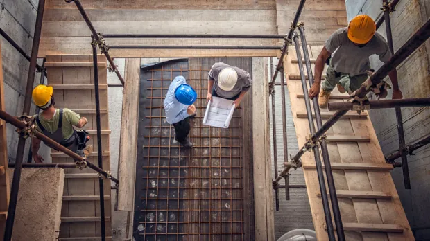 Construction workers and an architect viewed from above