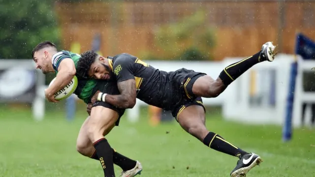 Rugby tackle in progress