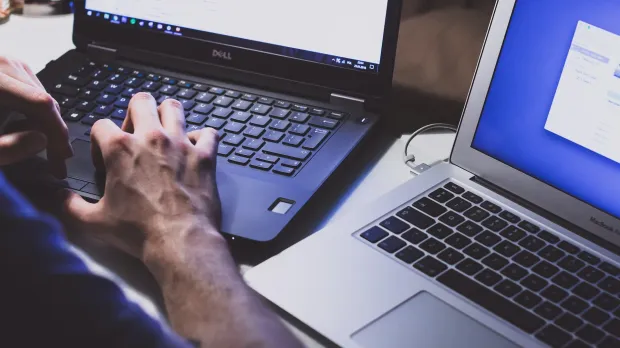 Cyber-security mistakes employee protecting computers with cyber-securty