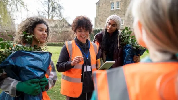 Community group in high-vis working together outdoors