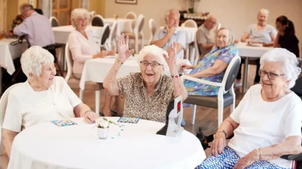 Older people sat enjoying a group activity