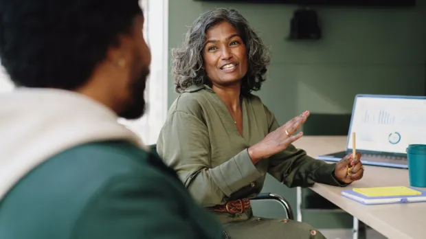 two people discussing work in a casual setting two people discussing work in a casual setting