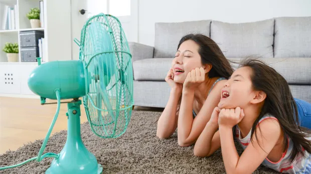Mom and kid in front of fan